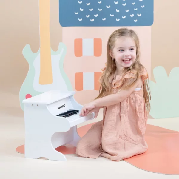 Момиче свири на детско клавирно пиано New Classic Toys в бял дървен цвят