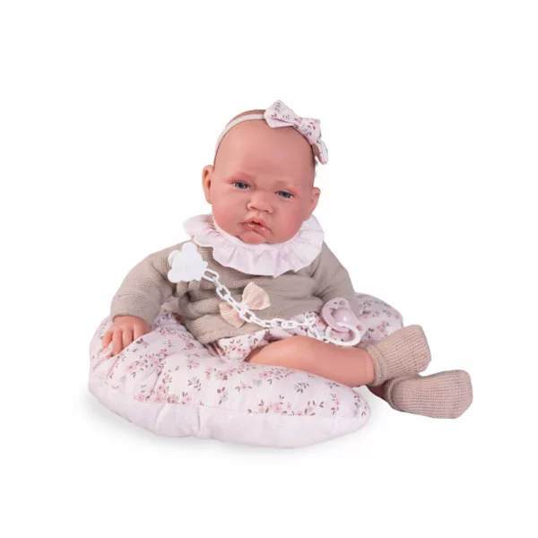 Кукла бебе Лили седнала на възглавница с розови цветчета