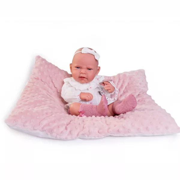 Кукла бебе Леа с бяла панделка на главата върху плюшена розова възглавница