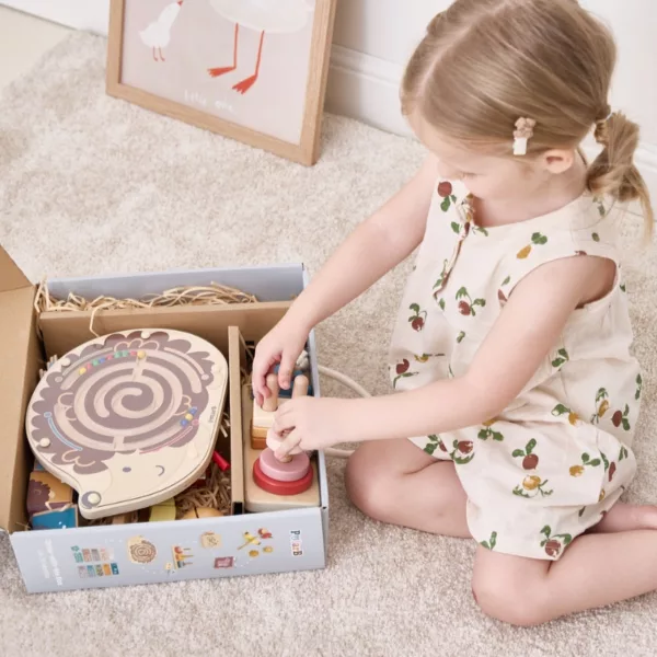 Момиченце разопакова Монтесори кутията от PolarB със сортер и магнитен лабиринт