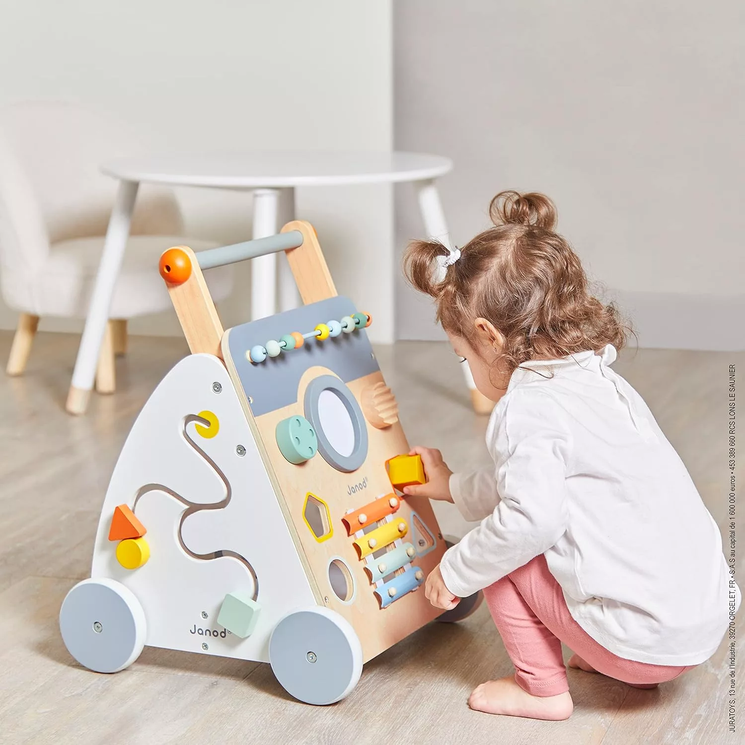Дете играе с дървена проходилка с активности Sweet Cocoon от Janod